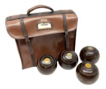 Four lignum vitae bowling woods in Slazenger carrying case