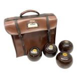 Four lignum vitae bowling woods in Slazenger carrying case