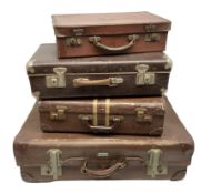 Four vintage suitcases of various sizes