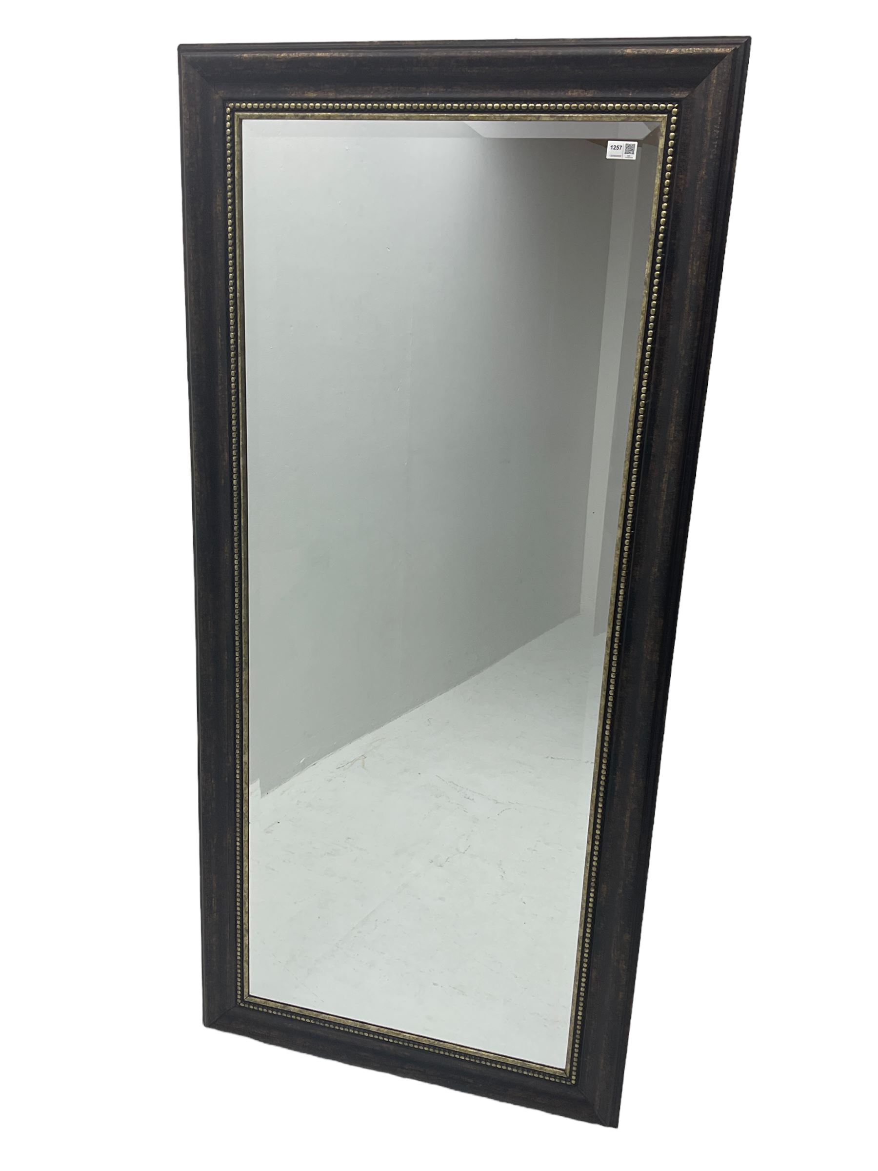 Bevelled wall mirror in bronze finish frame