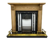 Cast metal fireplace in pine surround