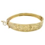 9ct gold hinged bangle with bright cut foliate decoration