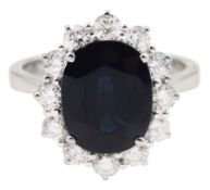 18ct white gold oval sapphire and round brilliant cut diamond cluster ring