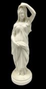 Parian ware figure of a woman in classical dress with one hand raised