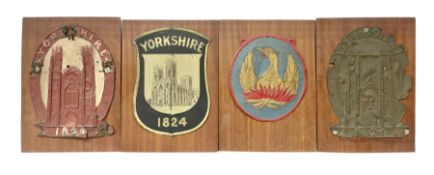 Four fire mark insurance plaques mounted on boards to include three Yorkshire examples and another d
