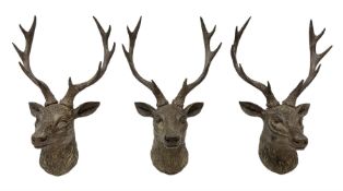 Three composite wall mounted stag heads with antlers