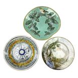 Majolica plate decorated with yellow and brown bird upon fruiting holly branches on teal ground with