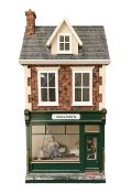 Good quality late 20th century dolls house by M. James dated 1996 in the form of 'Graysons' Shop wit