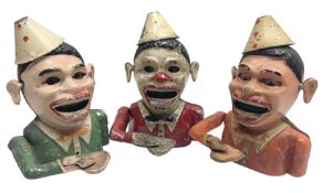 Three colour variations of Starkies white metal mechanical 'Clown' money bank c1920s H18.5cm (3)