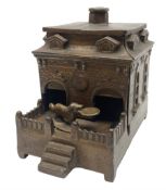 Late 19th century mechanical cast-iron money bank as a dog on a turntable revolving in and out of a