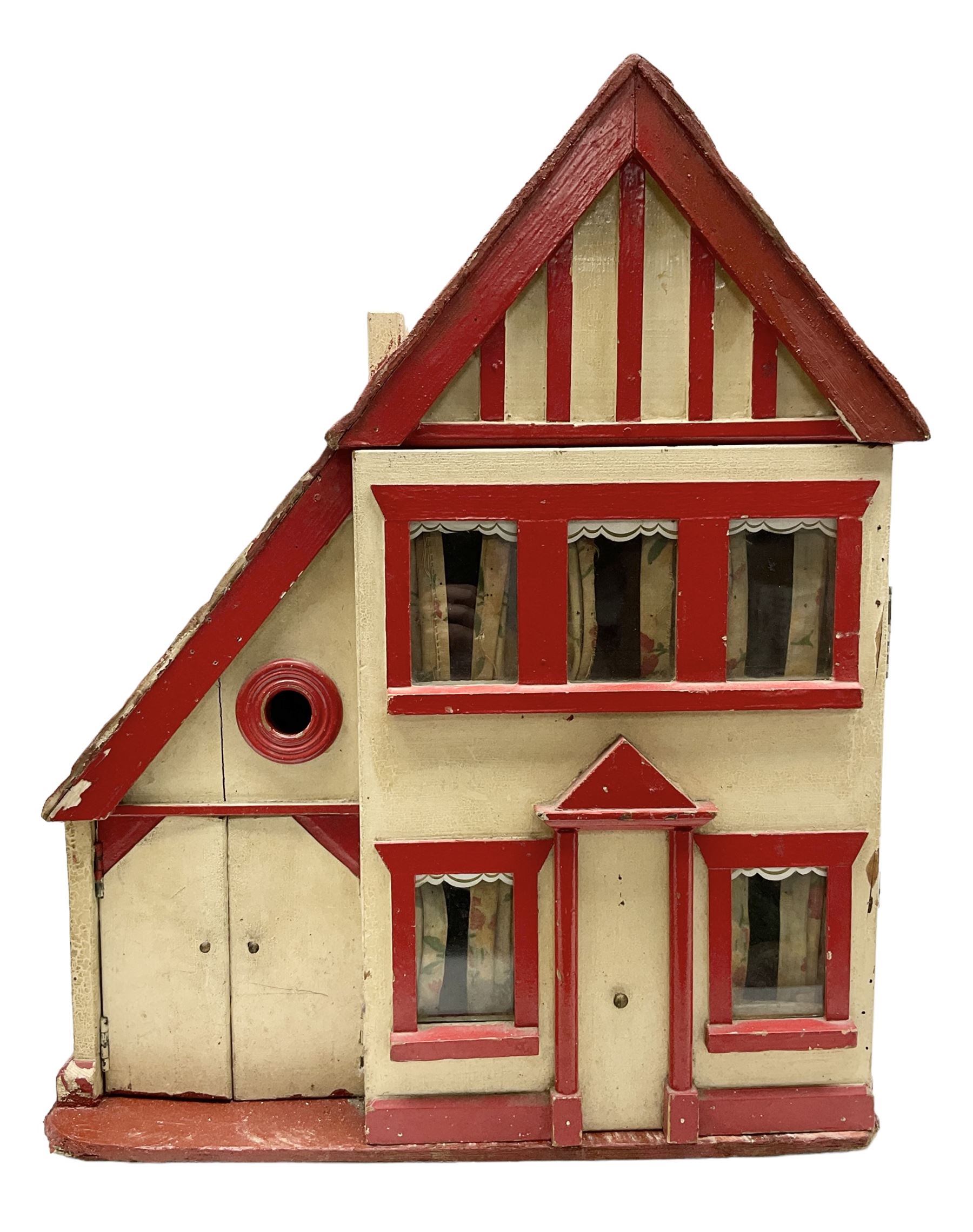 1960s scratch-built wooden doll's house as a red and white painted two-storey house with half-timber