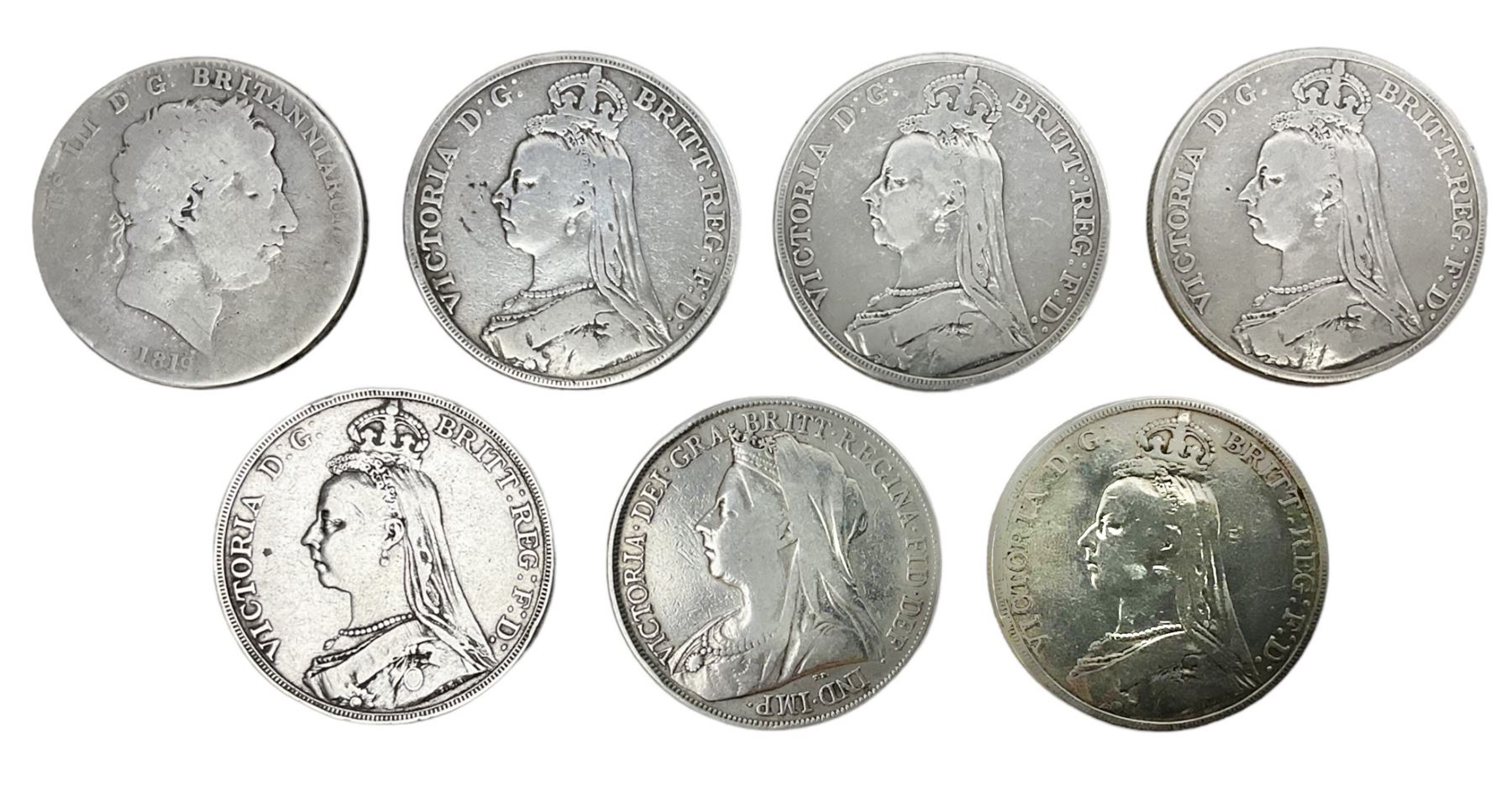 George III 1819 crown coin and six Queen Victoria crown coins dated 1889