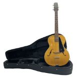 1950s acoustic guitar with f-holes and pickguard L105cm; black fur lined hard carrying case