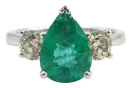 18ct white gold three stone pear shaped emerald and round brilliant cut diamond ring