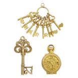 Three 9ct gold pendant/charms including clock and sand timer