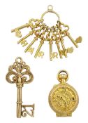 Three 9ct gold pendant/charms including clock and sand timer