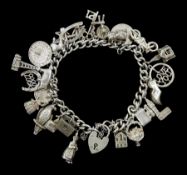 Silver curb link bracelet with heart locket clasp and twenty five silver charms including toby jug