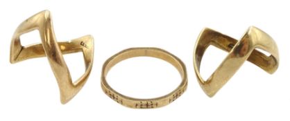 Two gold wishbone rings and a gold wedding band