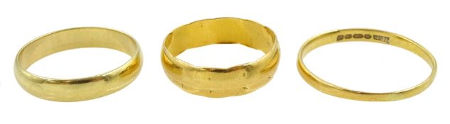 Two 22ct gold wedding bands and an18ct gold wedding band