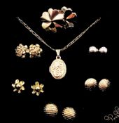 Gold locket pendant necklace and six pairs of gold stud earrings