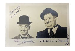 Stan Laurel and Oliver Hardy signatures on head and shoulder portrait of the two comedians inscribed