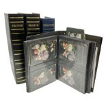 Four modern albums containing approximately eight-hundred and fifty Edwardian and later postcards in