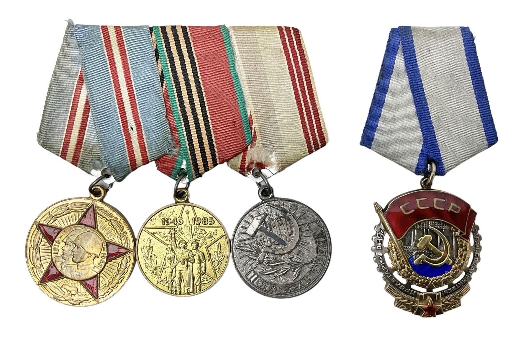 USSR Order of the Red banner of Labor Medal No.1173358; and a group of three other Russian medals in