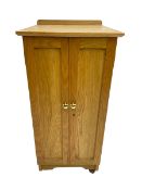 Bespoke light oak floor standing medal cabinet with two panelled doors enclosing fourteen graduated