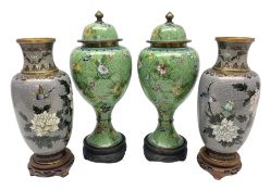 Pair of cloisonn� lidded vases of baluster form decorated with blooming branches of flowers upon pat