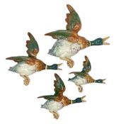 Set of four graduating Beswick flying duck wall plaques