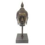 Bronze Buddha head upon a square marble base