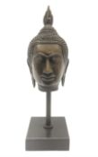 Bronze Buddha head upon a square marble base