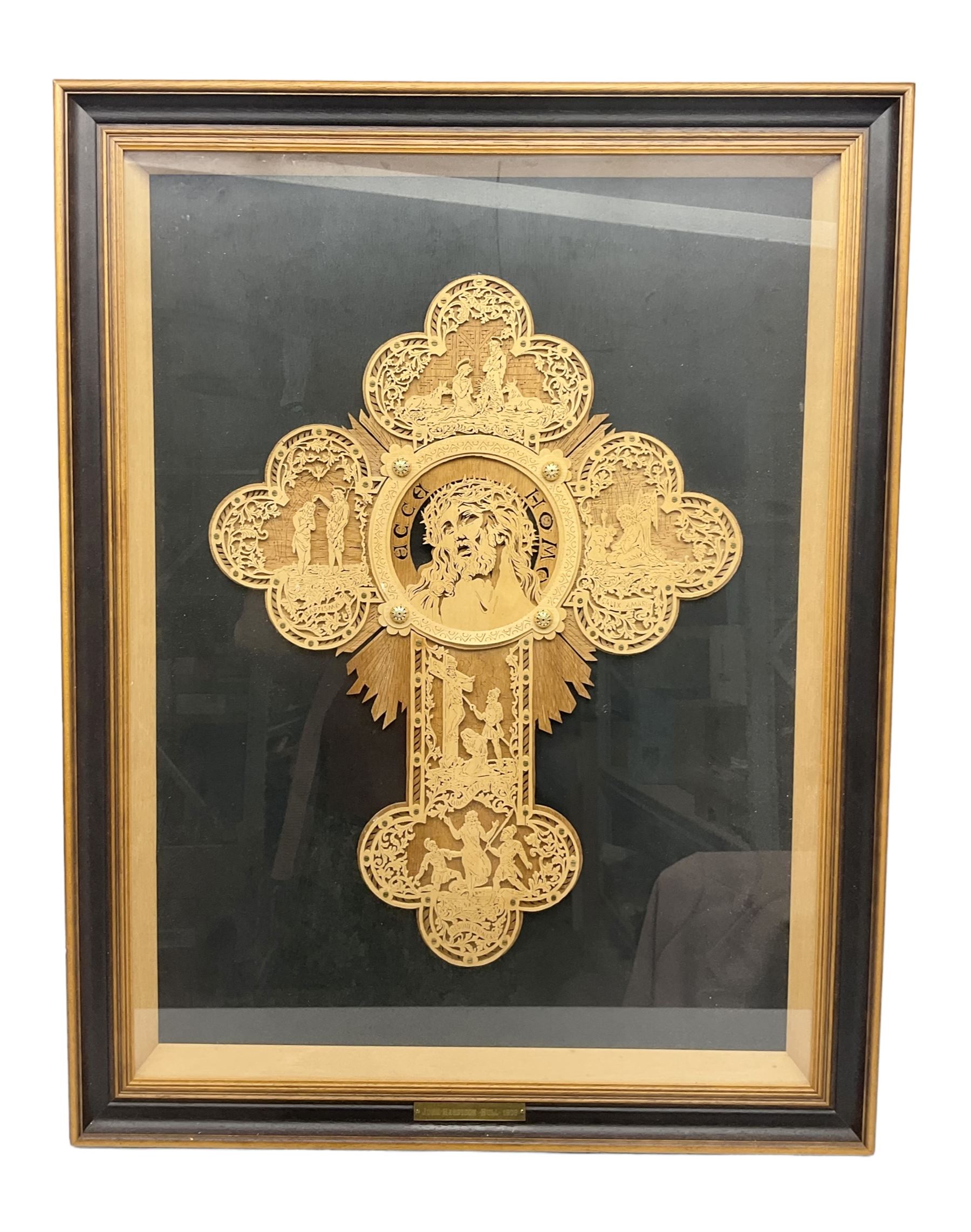 Cork carving of a religious cross depicting intricate scenes of various religious figures and motifs