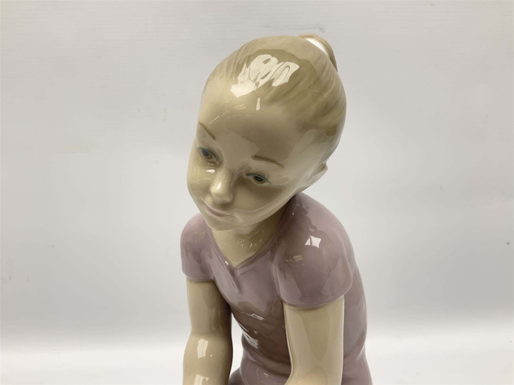 Large Nao figure modelled as a young girl seated upon a rock holding a rose - Image 2 of 6