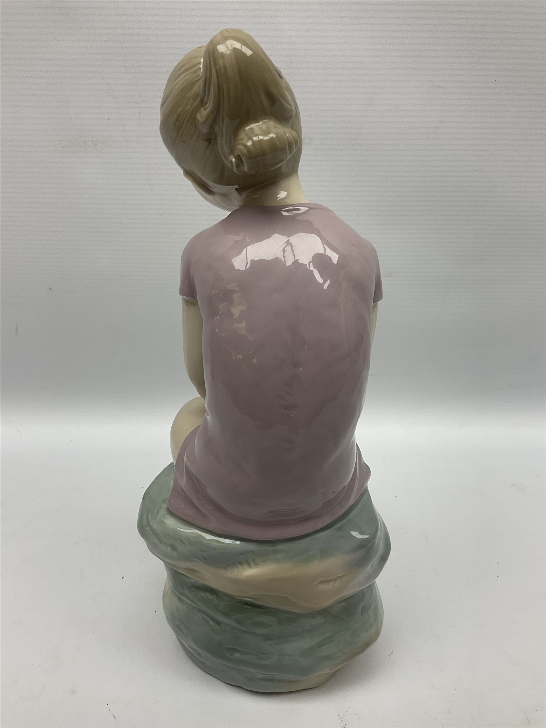 Large Nao figure modelled as a young girl seated upon a rock holding a rose - Image 5 of 6