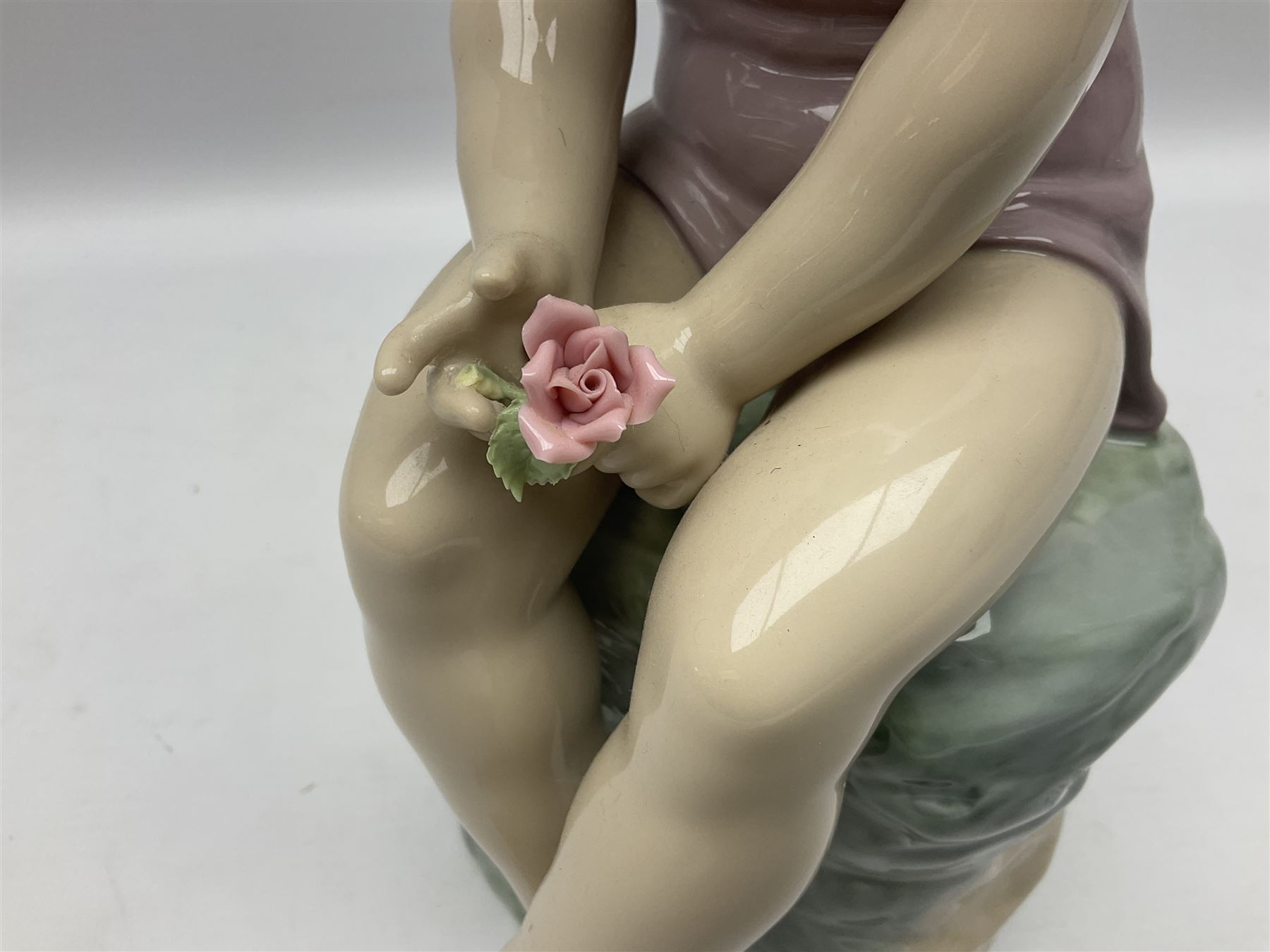 Large Nao figure modelled as a young girl seated upon a rock holding a rose - Image 4 of 6