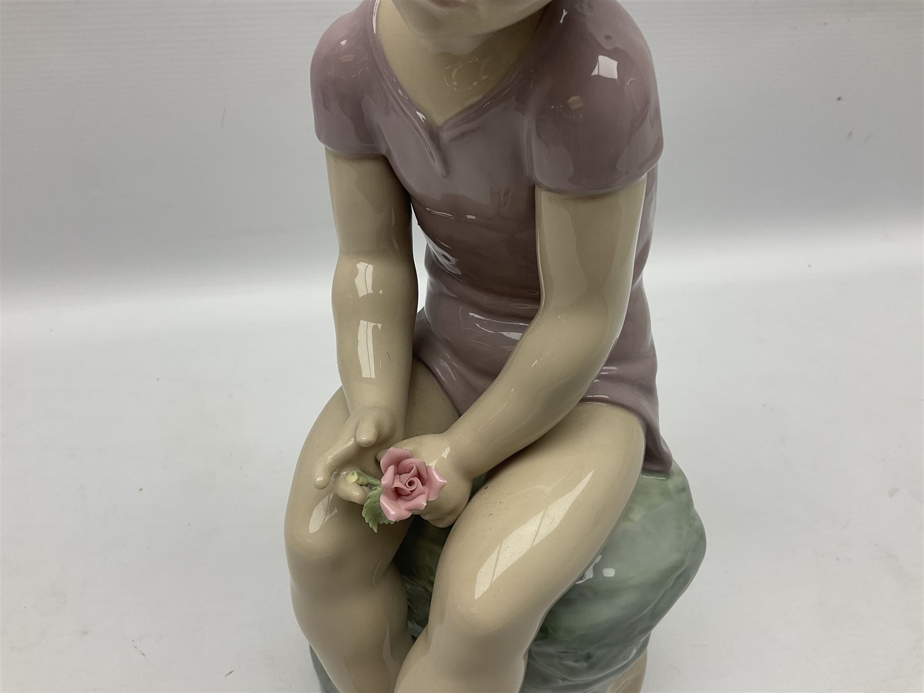 Large Nao figure modelled as a young girl seated upon a rock holding a rose - Image 3 of 6