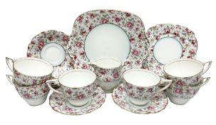 Windsor tea service for six decorated with blooming pink roses and purple flowers amongst foliage