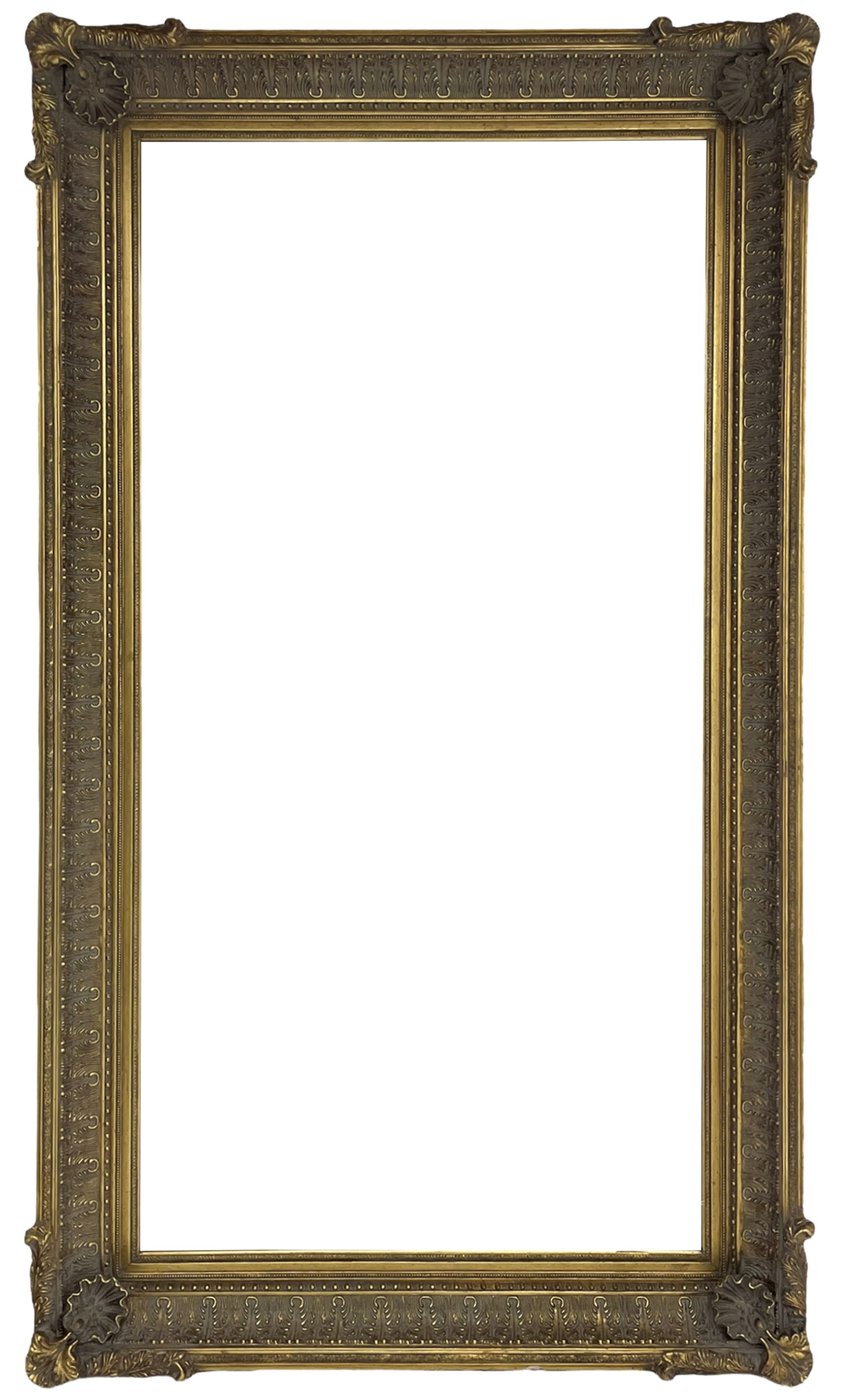 Large bevelled mirror in swept gilt frame
