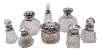 Group of eight silver mounted glass dressing table scent bottles and jars