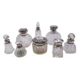 Group of eight silver mounted glass dressing table scent bottles and jars