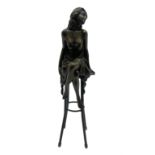 Art Deco style bronze modelled as a semi-nude female figure seated cross legged upon a chair
