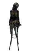 Art Deco style bronze modelled as a semi-nude female figure seated cross legged upon a chair