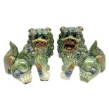 Pair of Chinese stoneware Fo dogs with merging green