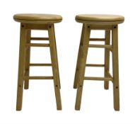 Two light oak bar stools with swivel tops