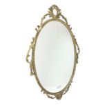 Ornate brass wall mirror with oval plate