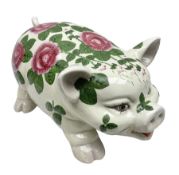 Large ceramic figure of a pig decorated with roses