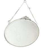 Wall mirror of oval form with stylised mount and bevelled plate