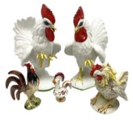 Pair of fighting cockerels from Italy together with three other ceramic cockerels