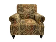 Traditional shaped armchair upholstered in patterned fabric